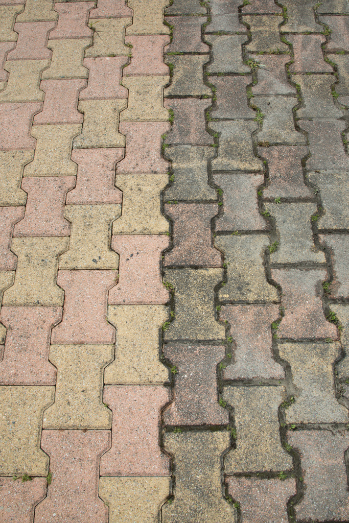 Contrast between patio paving slabs which have been pressured washed before and after cleaning